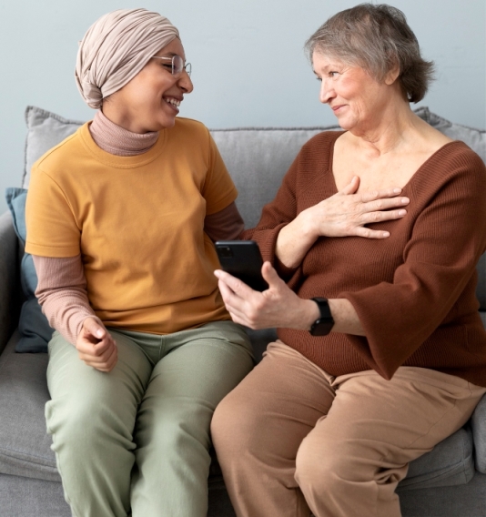 arabic-woman-is-teaching-senior-woman-use-smartphone-living-room