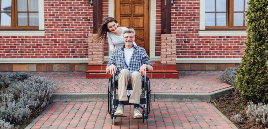 enjoying-family-time-elderly-man-wheelchair-smiling-daughter-garden