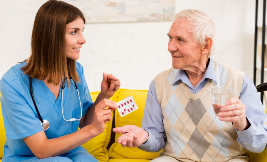 nurse-giving-old-man-his-pills