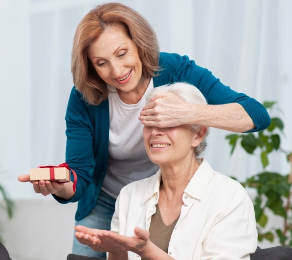 senior-woman-surprising-her-friend